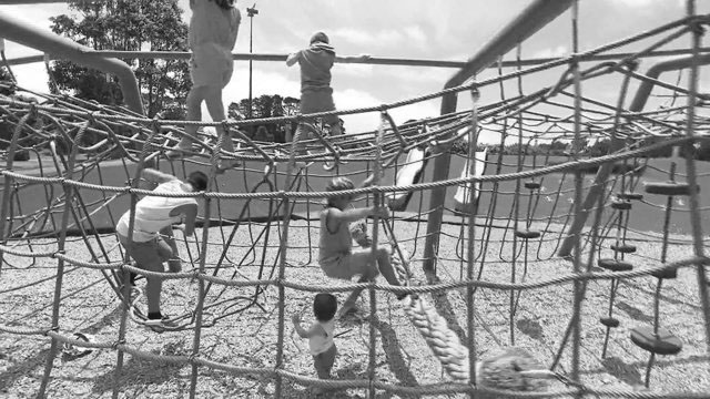 Children playing on rope playground.