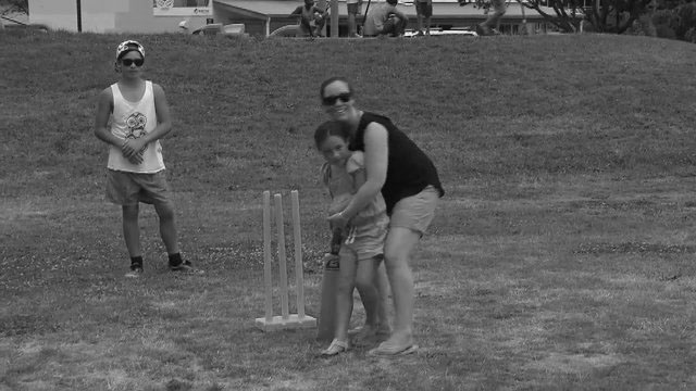 Mum playing cricket with daughter.
